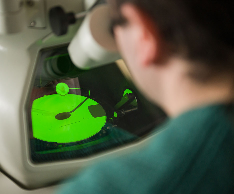 man looking in microscope