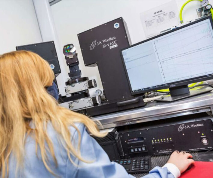 Lady working with the JA Woollam Infrared Variable Angle Spectroscopic Ellipsometer (IR-VASE).