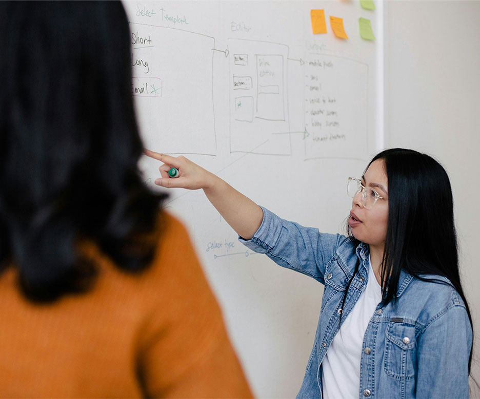 Woman looking at post-its with client