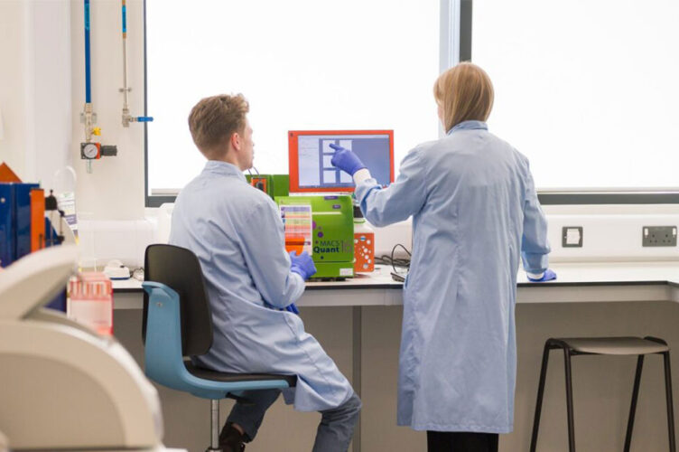 Two researchers looking at a screen