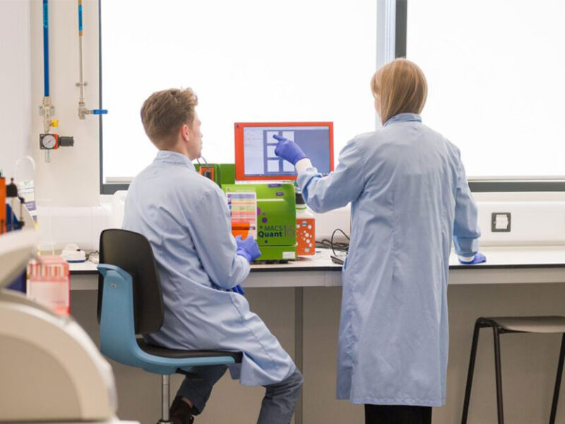 Two researchers looking at a screen