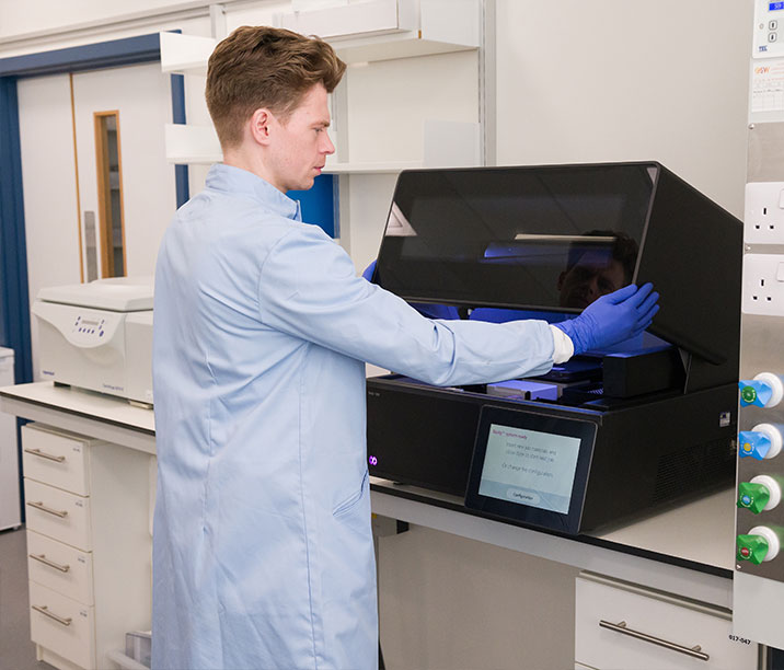 Researcher examining DNA printer